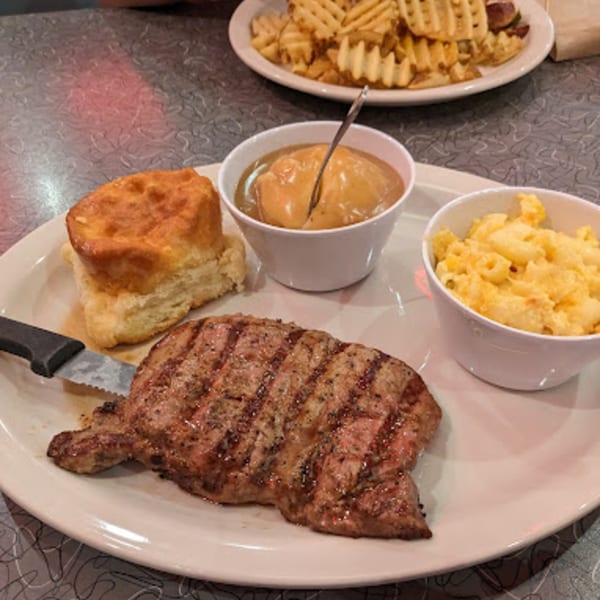 Grilled steak, biscuit, mashed potatoes with gravy, and mac and cheese from RedEye Diner.